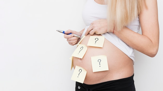 Pregnant woman with notes on body