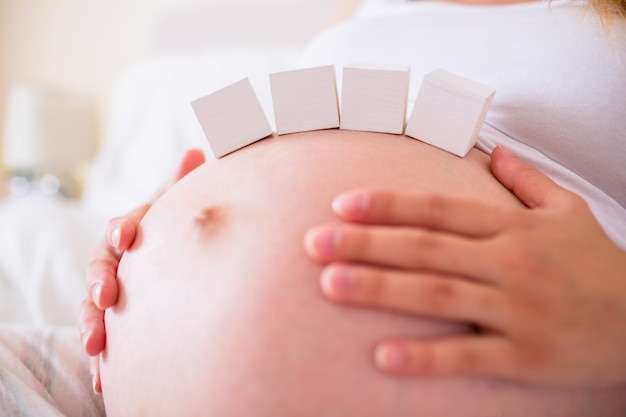 Pregnant woman with paper block on belly 