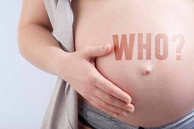 Pregnant woman with title who on her her belly