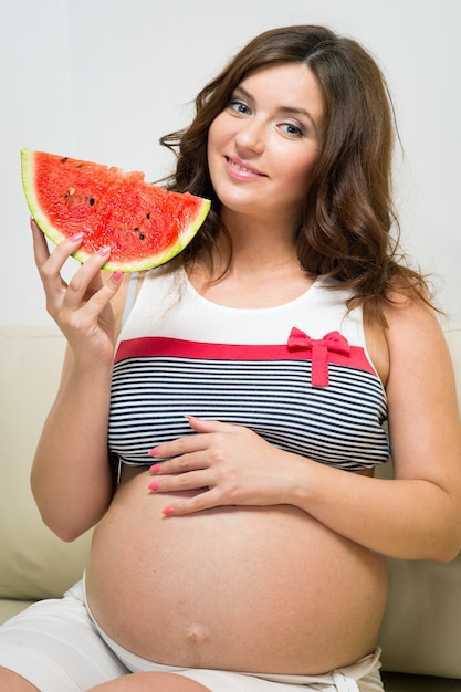 Pregnant woman with watermelon in hands