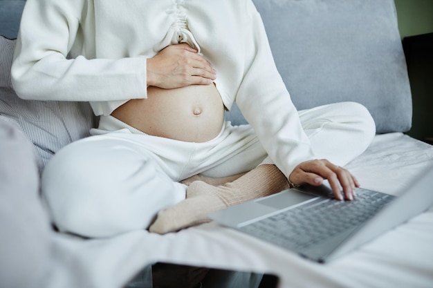 Pregnant woman working online at home