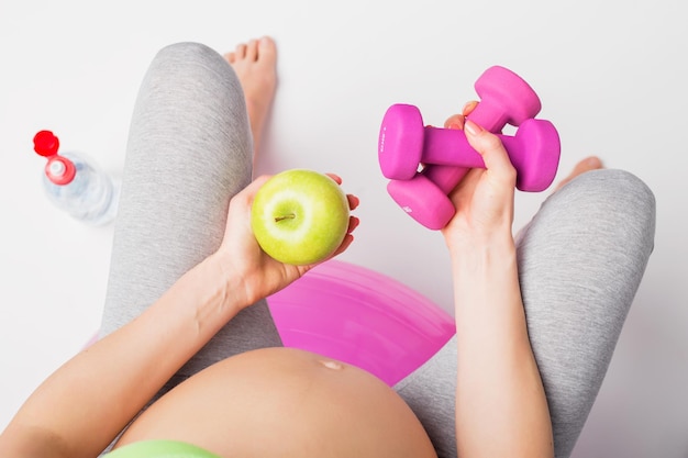 Pregnant woman working out on medicine ball