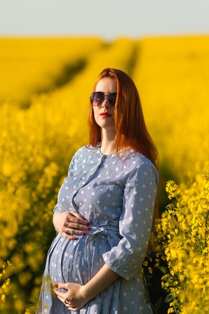 Pregnant woman in yellow field