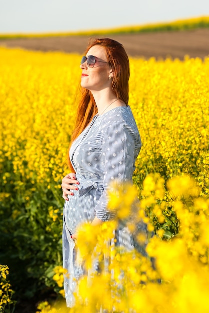 Pregnant woman in yellow field