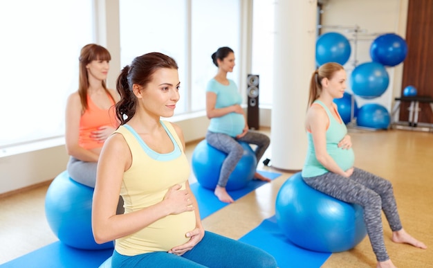 pregnant women sitting on exercise balls in gym