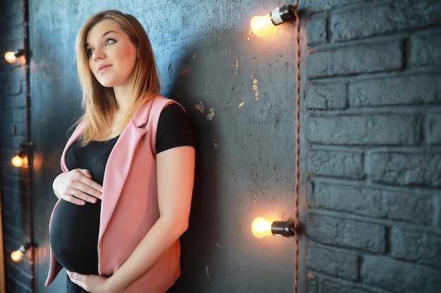 Pregnant young beautiful girl on the ninth month indoor