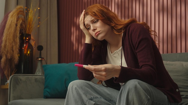 Pregnant young girl caucasian woman female at home stress unwanted pregnancy check positive or