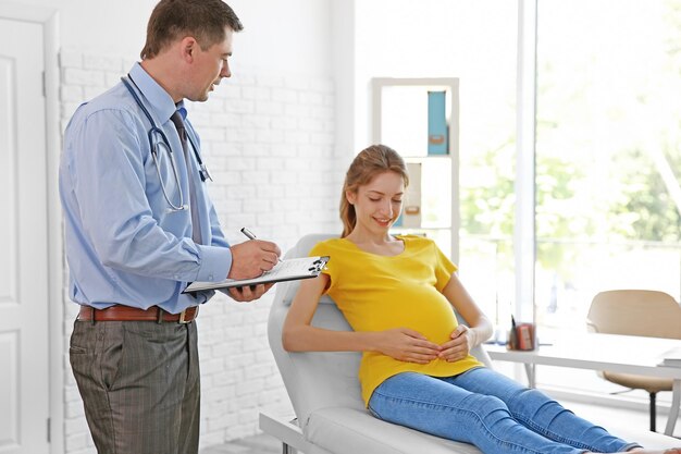 Pregnant young woman visiting doctor