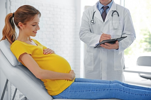 Pregnant young woman visiting doctor