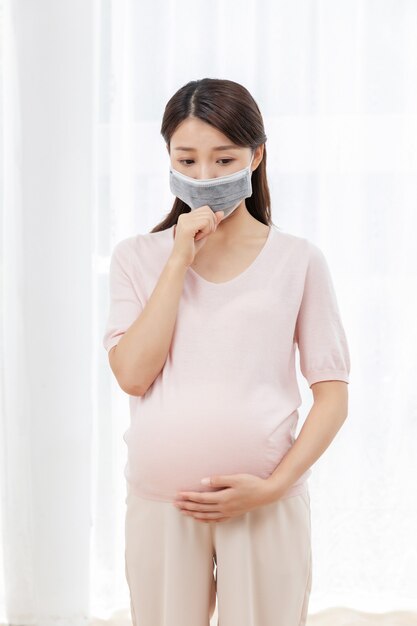 Pregnant young woman with a mask