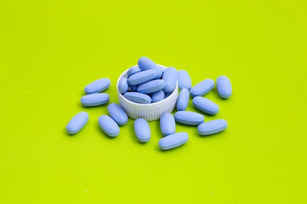 Prep (pre-exposure prophylaxis) used to prevent hiv. blue pills on green surface