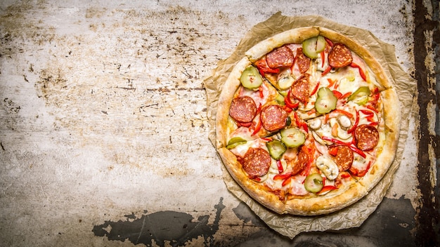 Preparated meat pizza On old paper.