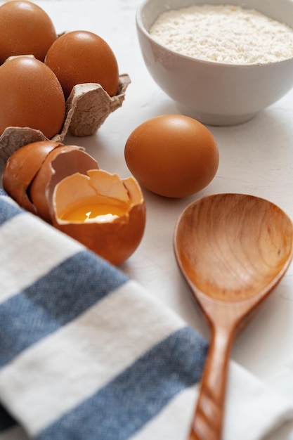 Preparation for baking eggs and flour on white background