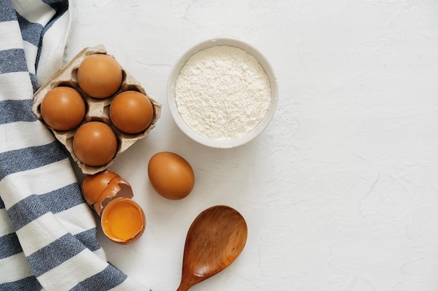 Preparation for baking eggs and flour on white background