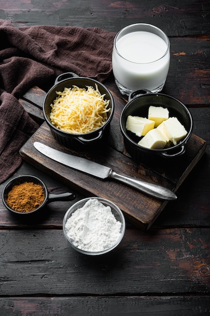 Preparation of bechamel cheese white sauce set, on old dark  wooden table