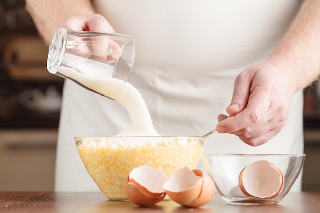 Preparation bread cooking,pouring the sugar in the the bowl