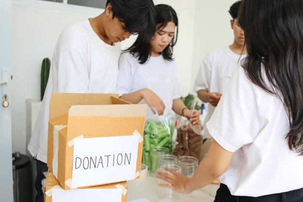 Photo preparation for charity event humanitarian activist packing food for donation