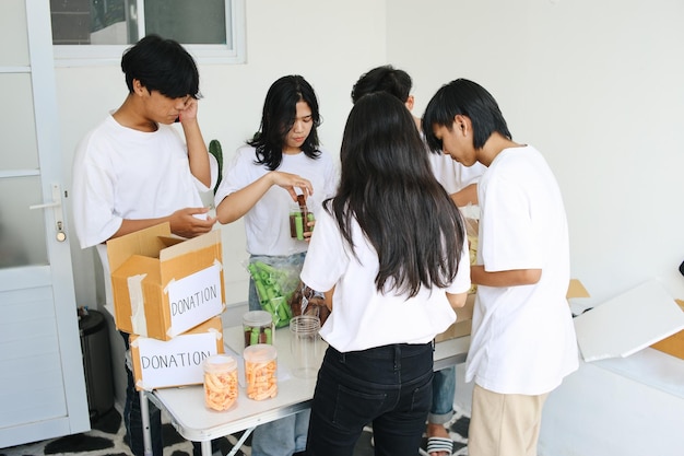 Photo preparation for charity event humanitarian activist packing food for donation