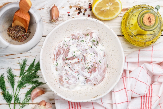 Preparation chicken fillet (nuggets) in a sauce of Greek yogurt with lemon, garlic, dill and spices