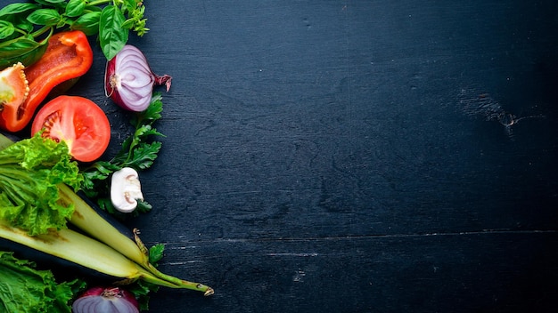 Preparation for cooking fresh vegetables on a wooden background Top view Free space for text