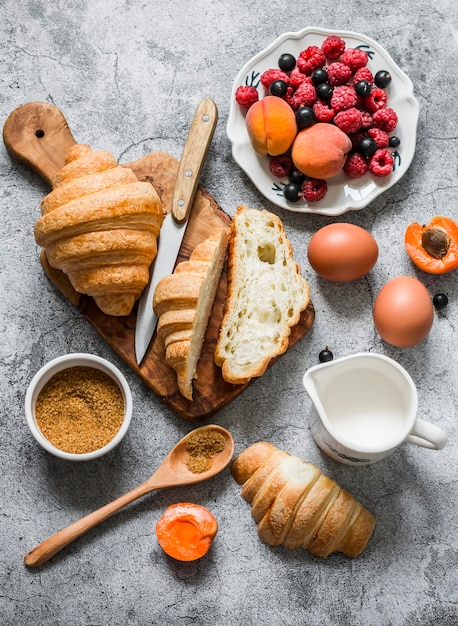 Preparation croissants brown sugar cinnamon baked French toast with berries on a gray background top view