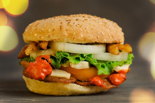 Preparation of delicious chicken burger Delicious burger on wood table background