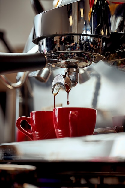 Preparation of espresso in a coffee machine A drop of coffee falls into the cup