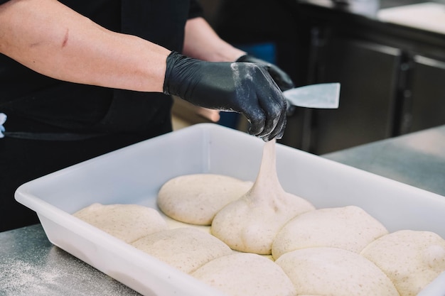 Preparation of a homemade Italian style pizza by a specialist