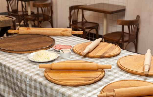 Preparation for a master class on cooking pizza in the kitchen in a cafe. Cooking pizza in the pizzeria.