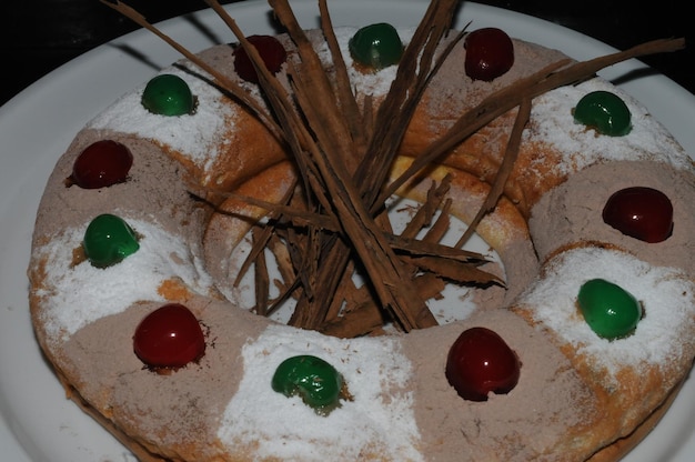 Preparation of an orange sponge cake sprinkling icing sugar on the decoration