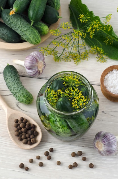 Preparation for pickling cucumbers with spices on awhite wooden table. Top view.