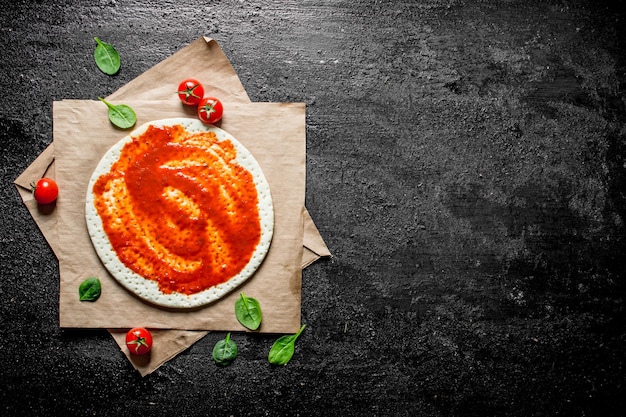 Preparation pizza Rolled out dough with tomato paste