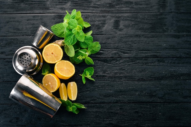 Preparation for preparing a cocktail of citrus fruit and mint Lemon grapefruit lime orange On a wooden background Top view