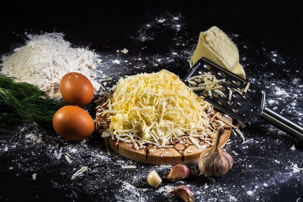 Preparation of the process of cooking cheese balls with garlic and dill on a black background