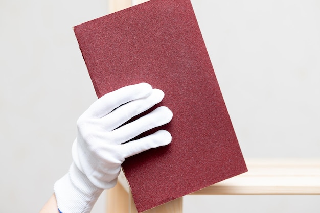 Preparation for repair and painting of furniture sanding the surface with sandpaper