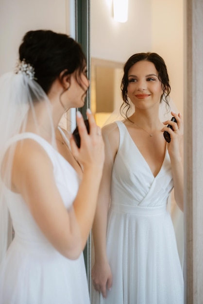 Photo preparations for the bride with the dressing of the wedding dress