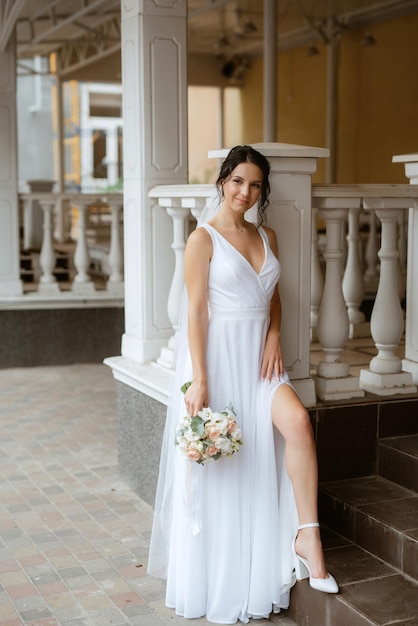 Preparations for the bride with the dressing of the wedding dress