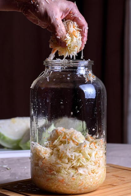 Prepare for fermentation Finely chopped cabbage is poured from the hands into a vessel for further sourdough white cabbage for sourdough