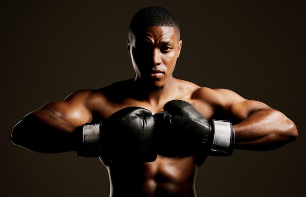 Prepare to meet your fate Studio shot of a handsome young man boxing against a black background