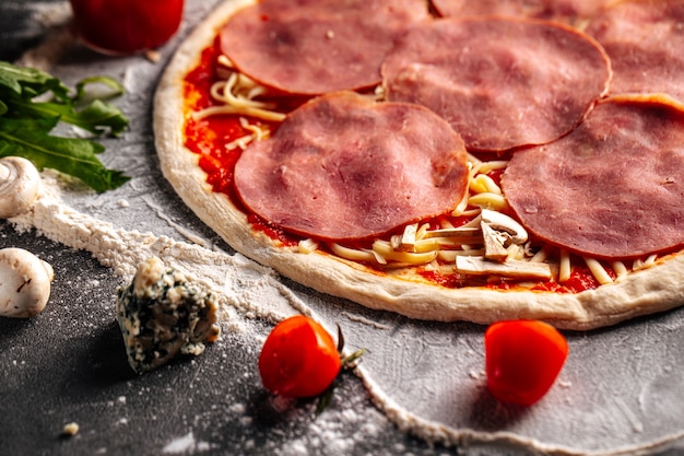 Prepared dough base for pizza with toppings