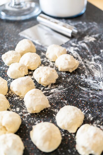 Preparing bread dough on the kitchen counter to bake flatbread.