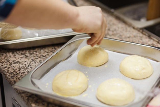 Preparing burger buns, making burgers.