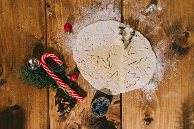 Preparing christmas cookies on a wooden surface