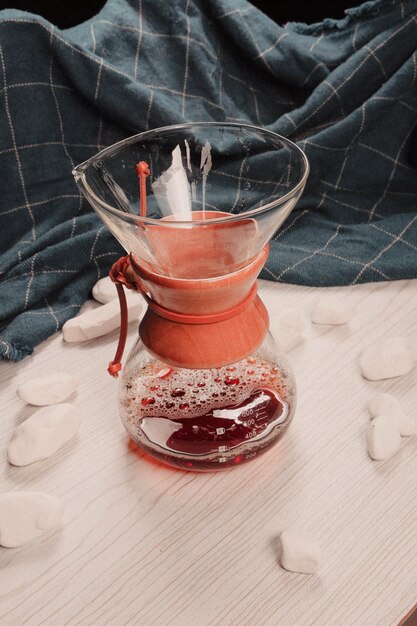 Photo preparing coffee with coffee plunger or chemex