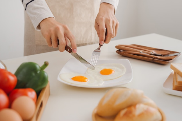 Preparing and eating breakfast at home in morning.