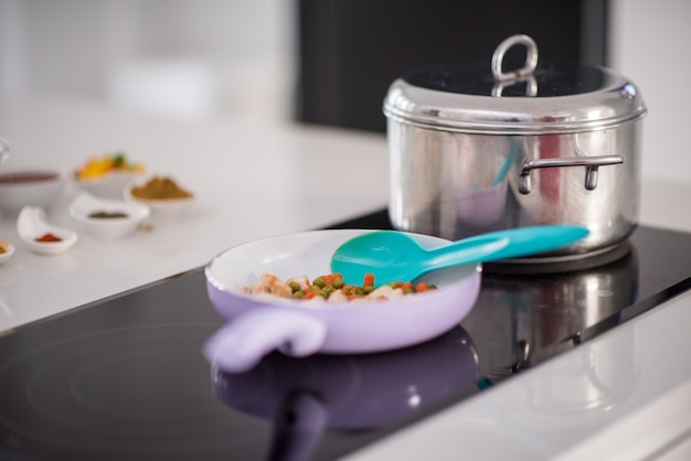 Preparing food in modern white kitchen