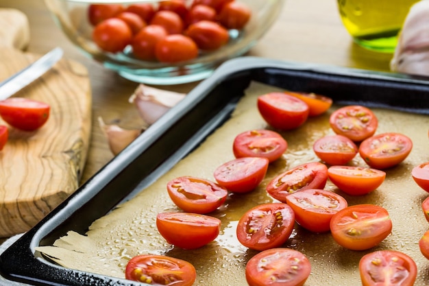 Photo preparing fresh roasted cherry tomatoes.