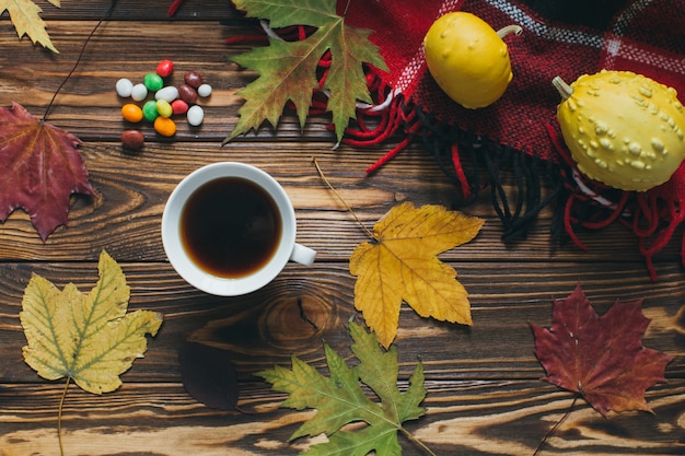 Preparing for Halloween: Autumn decor, pumpkins, plaid, leaf, candy and coffee.