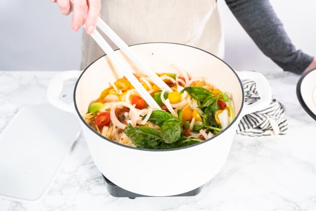 Preparing one pot pasta in enameled cast iron dutch oven.