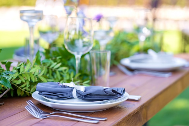 Preparing for an open-air party. Decorated with fresh flowers served tables. Table number. Decoration Details.